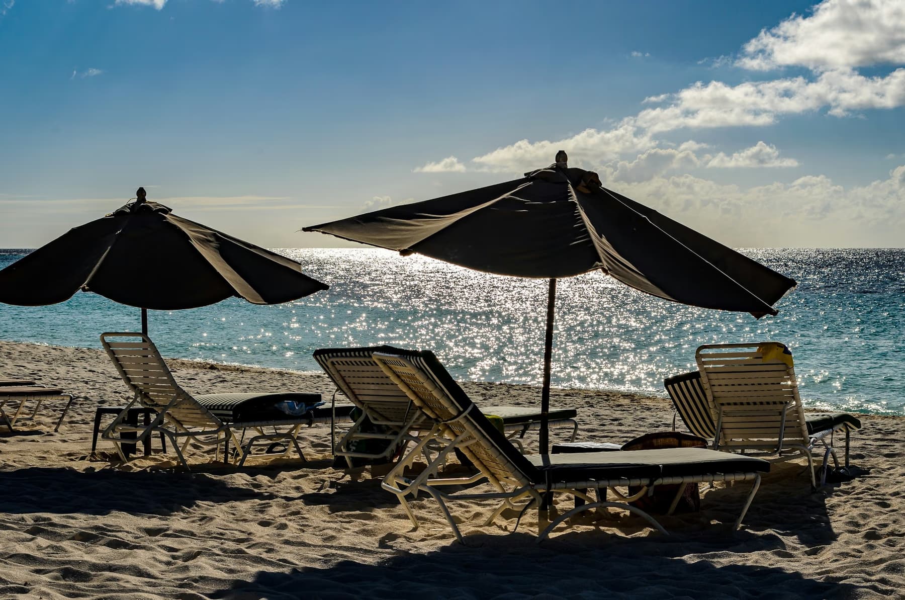 Sun loungers and umbrellas on a beach in Anguilla, looking out to sea