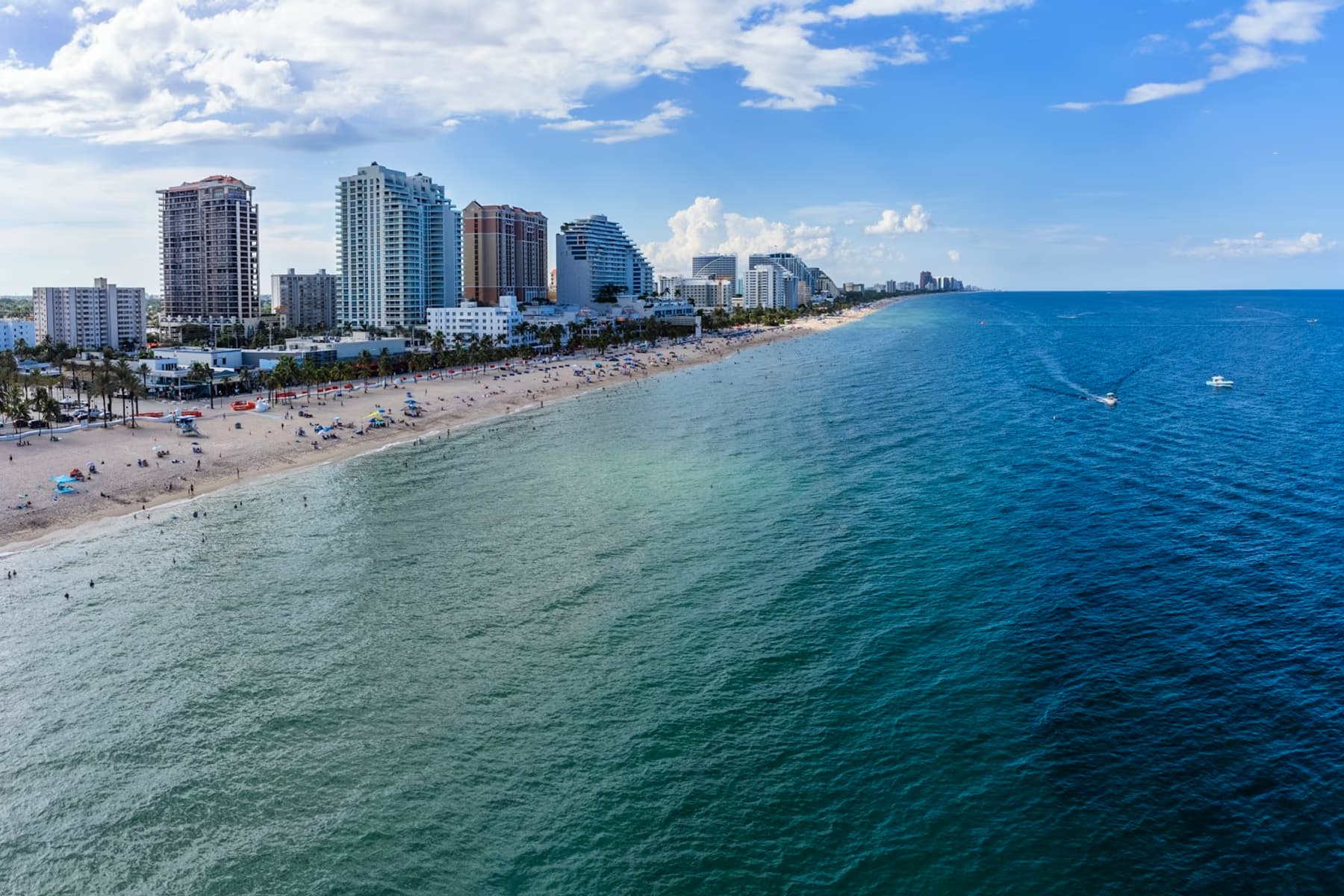 Aerial view of Fort Lauderdale Beach with turquoise water, sand and the city's buildings behind