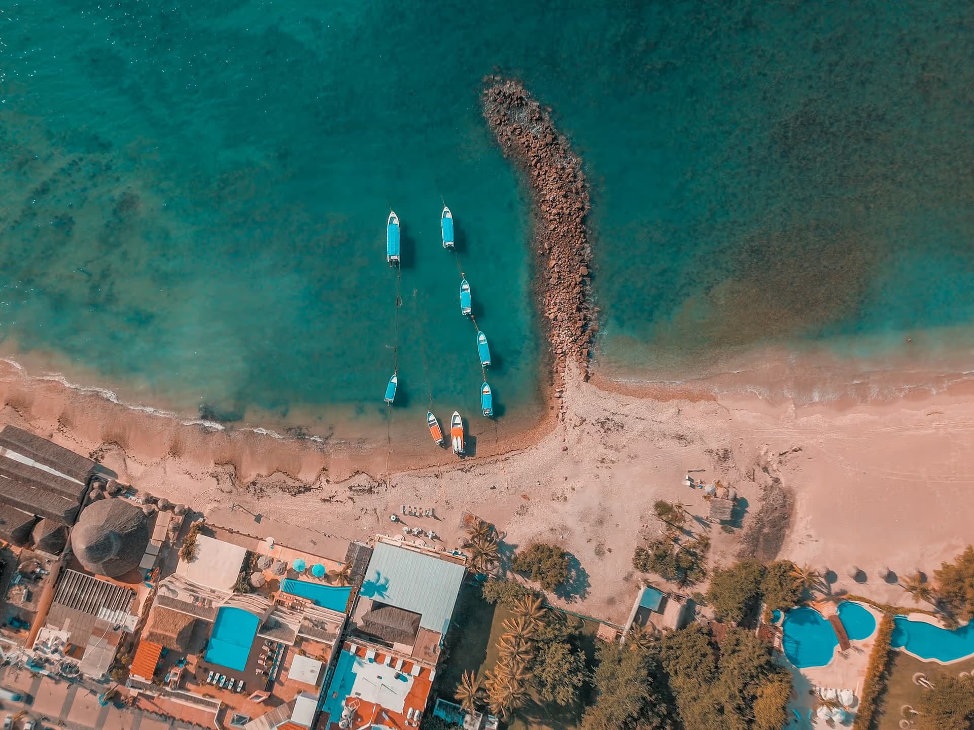 Boats pulled up on a small sandy beach near Punta Mita, seen from above