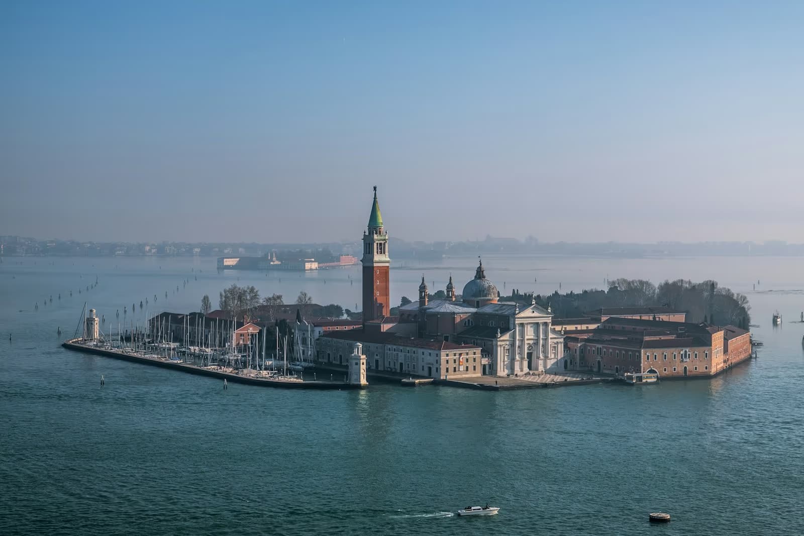 The island of San Giorgio Maggiore, with its church and bell tower, in the Venetian lagoon on a hazy morning