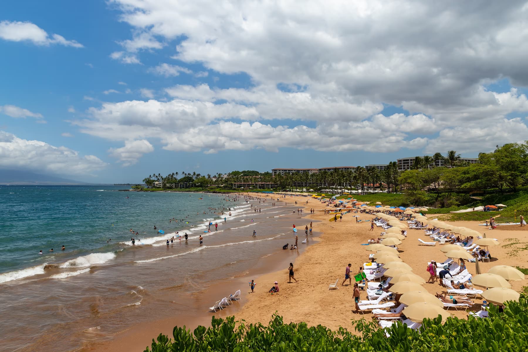 Loungers and umbrellas along the golden sand of Wailea Beach on the south shore of Maui